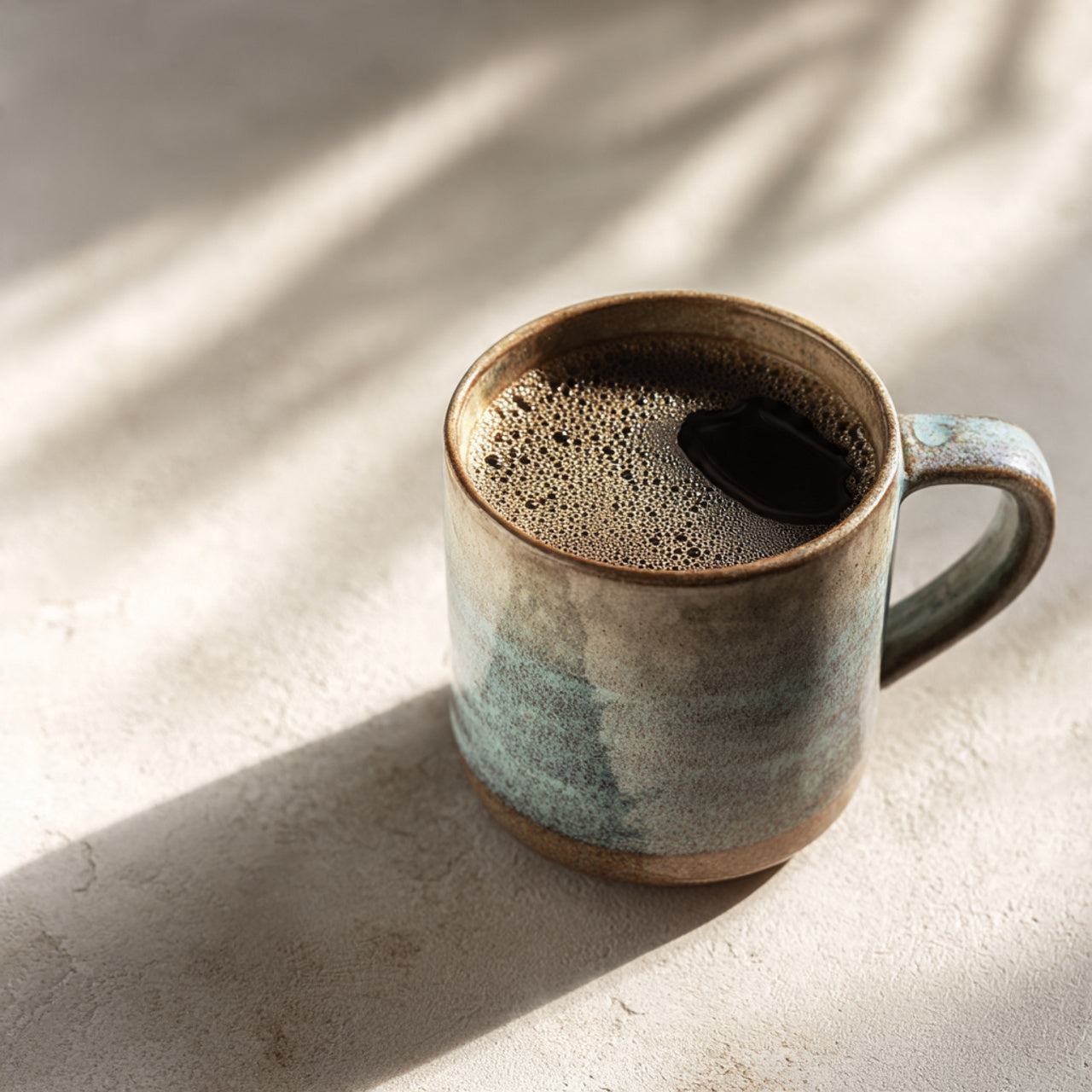 Ceramic mug with brazil coffee on a light surface with shadows