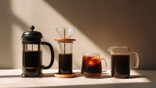 Different coffee brewing methods including French press, pour over, espresso, and cold brew on a clean surface