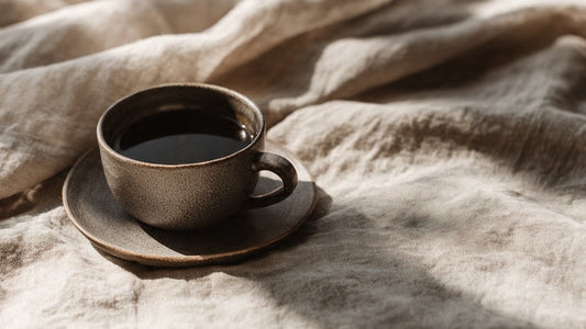 Peruvian coffee served black in ceramic cup with soft earth tones and Andean inspired editorial styling