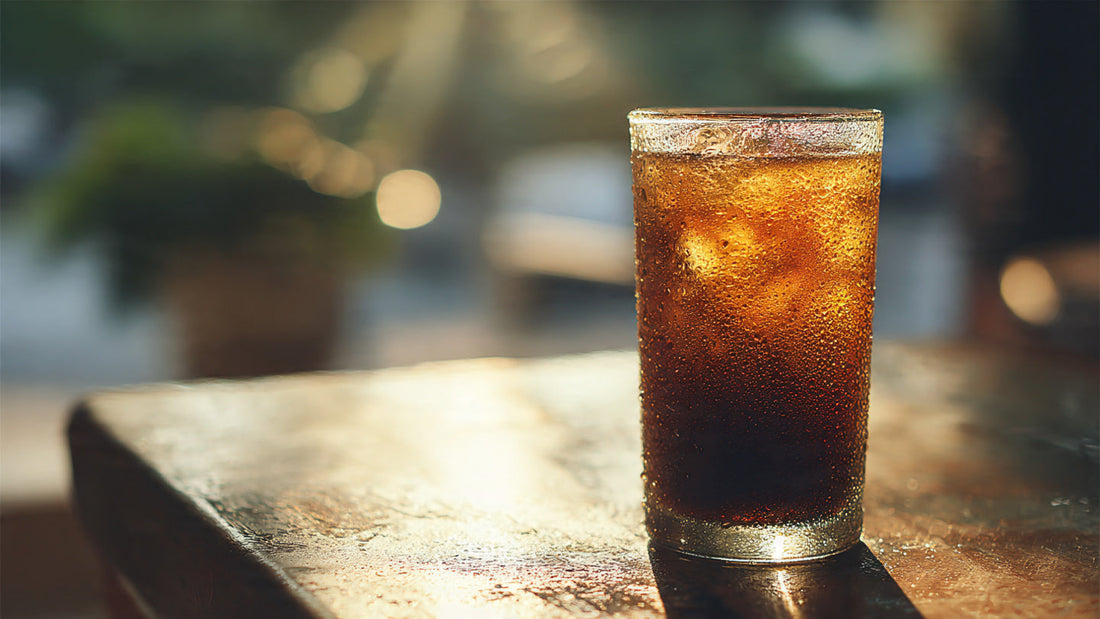 Iced cold brew coffee in tall glass with condensation.