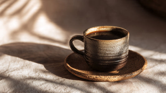 Ugandan single origin coffee in ceramic cup with bold fruity tones and warm editorial lighting