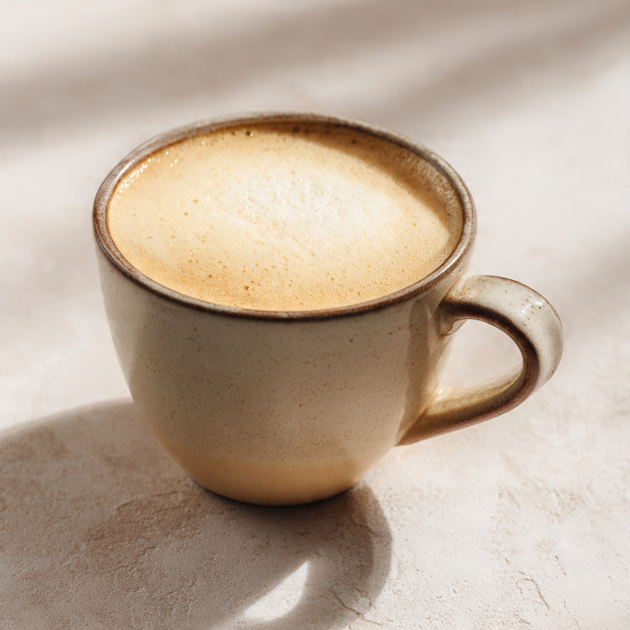 coffee on table with chair and blanket in background