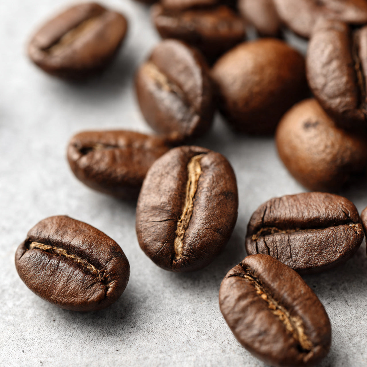 Close-up of roasted coffee beans on a textured surface
