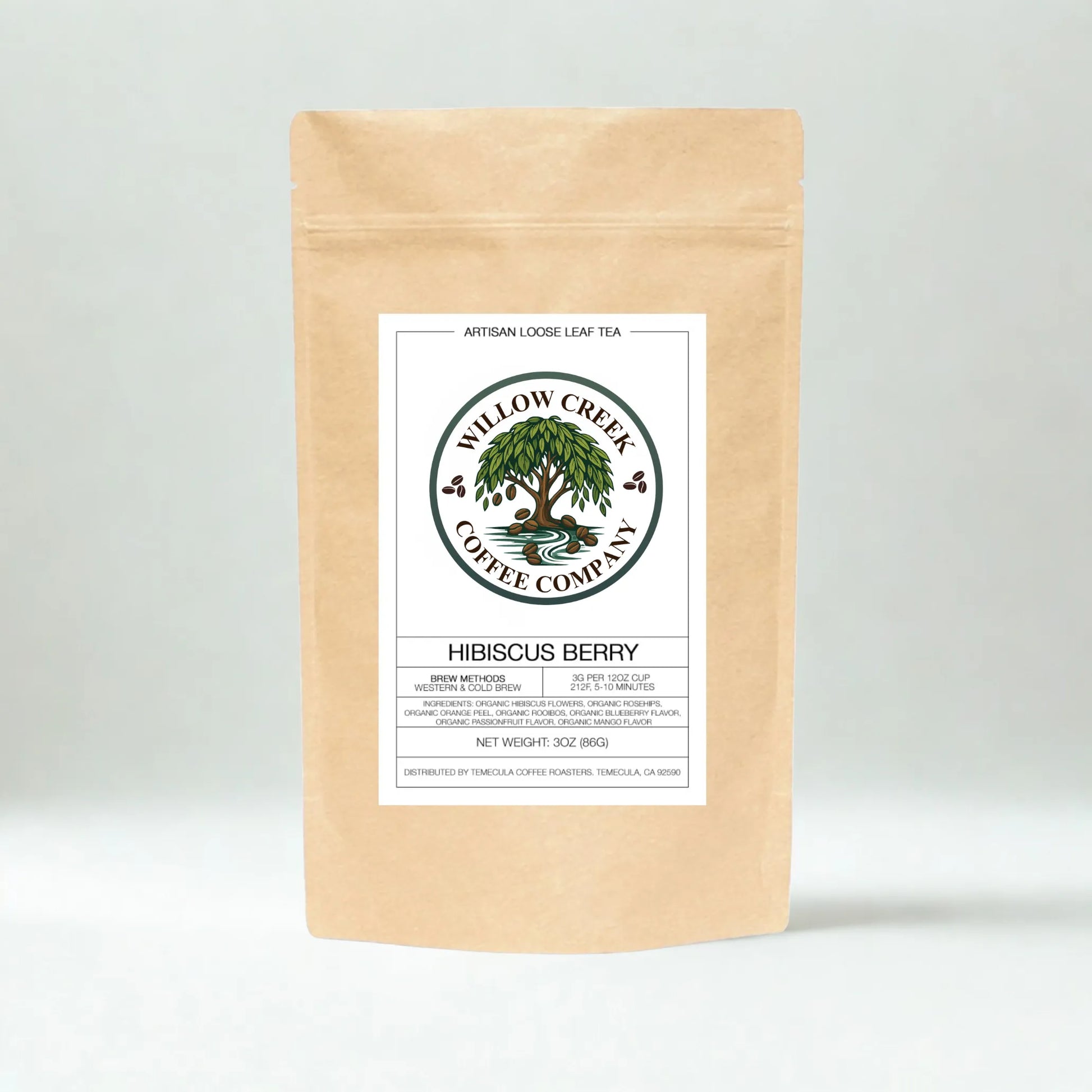 Kraft paper tea bag with Hibiscus Tea Willow Creek Coffee Company label on a light gray background