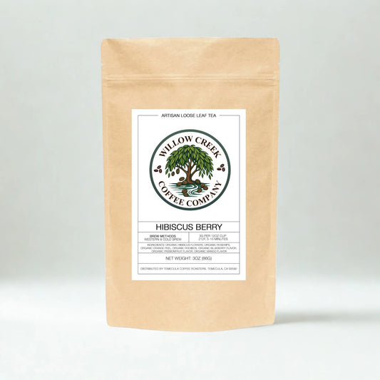 Kraft paper tea bag with Hibiscus Tea Willow Creek Coffee Company label on a light gray background