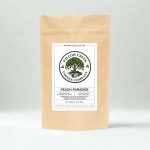 Kraft paper Peach Paradice tea bag with Willow Creek Coffee Company label on a light gray background