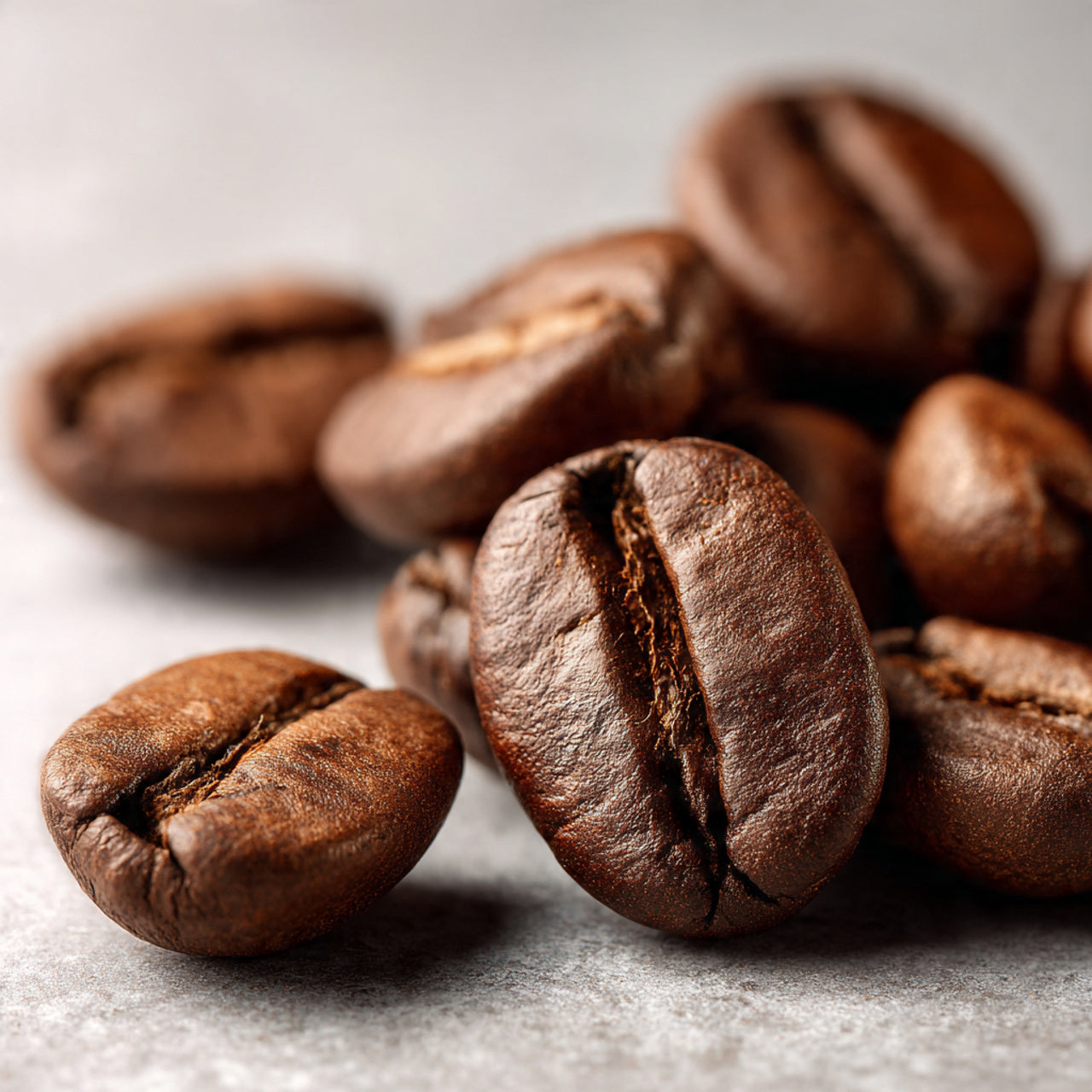 Close-up of blonde blend 
roasted coffee beans on a light background