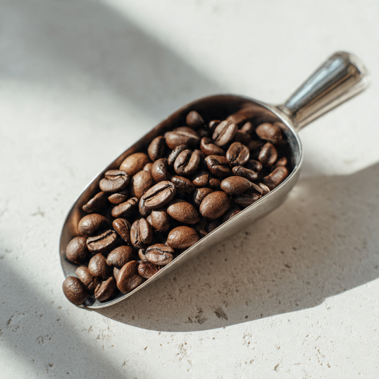  scoop filled with brazil  coffee beans on a light surface