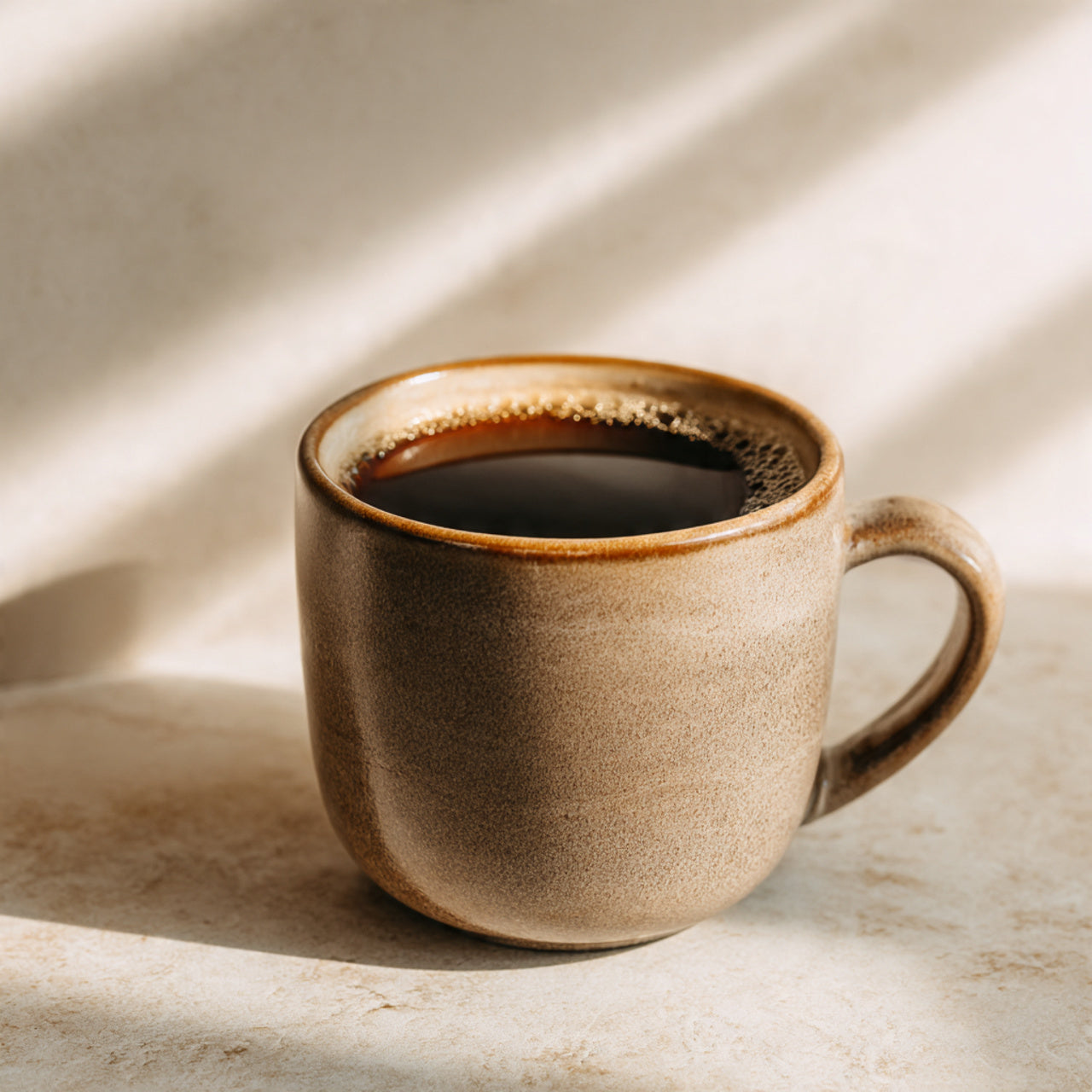 Brown ceramic mug with hazelnut  coffee on a light background
