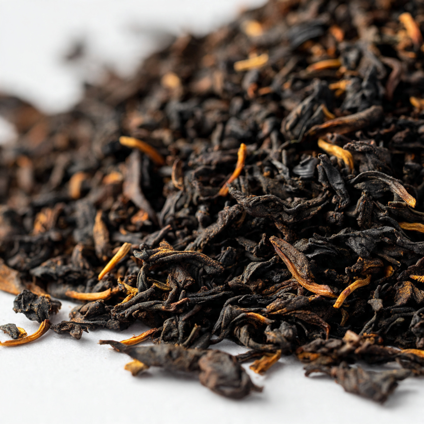 Close-up of  english-breakfast dried black tea leaves on a white background