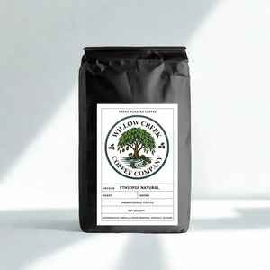 Black coffee bag with Willow Creek Coffee Company label on a light gray background