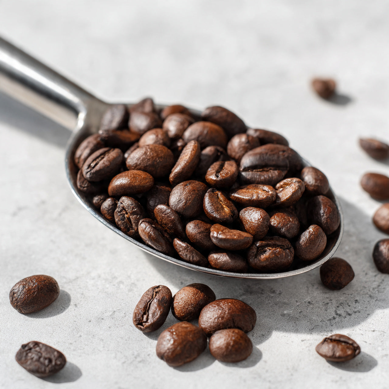 Spoonful of nicaragua coffee beans on a light surface