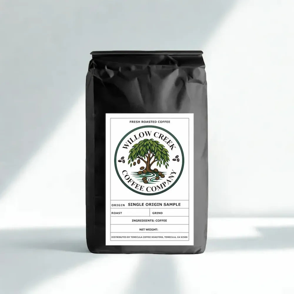 Black coffee bag with Willow Creek Coffee Company label on a light gray background